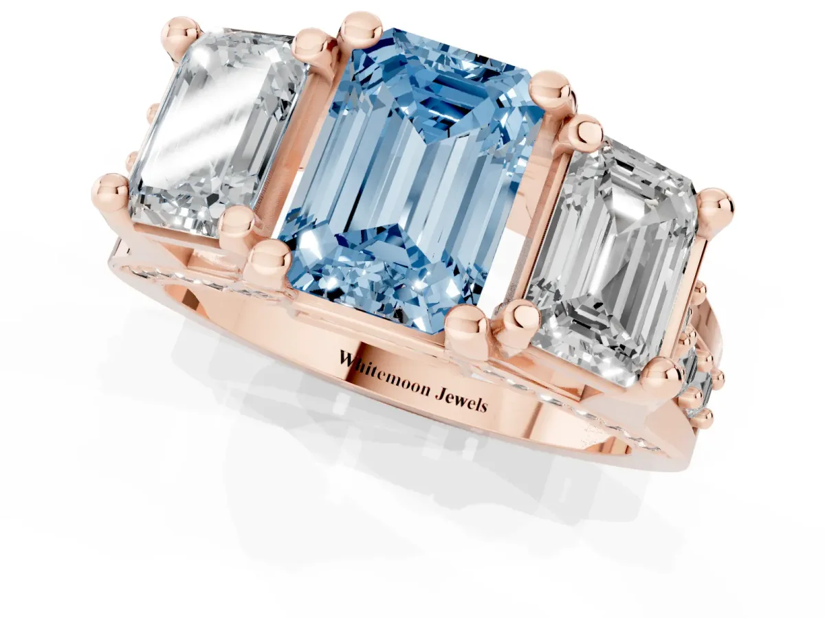 Fancy Blue Emerald Cut Diamond Three-Stone Ring with Channel Set Band and Four-Prong Setting Rose gold