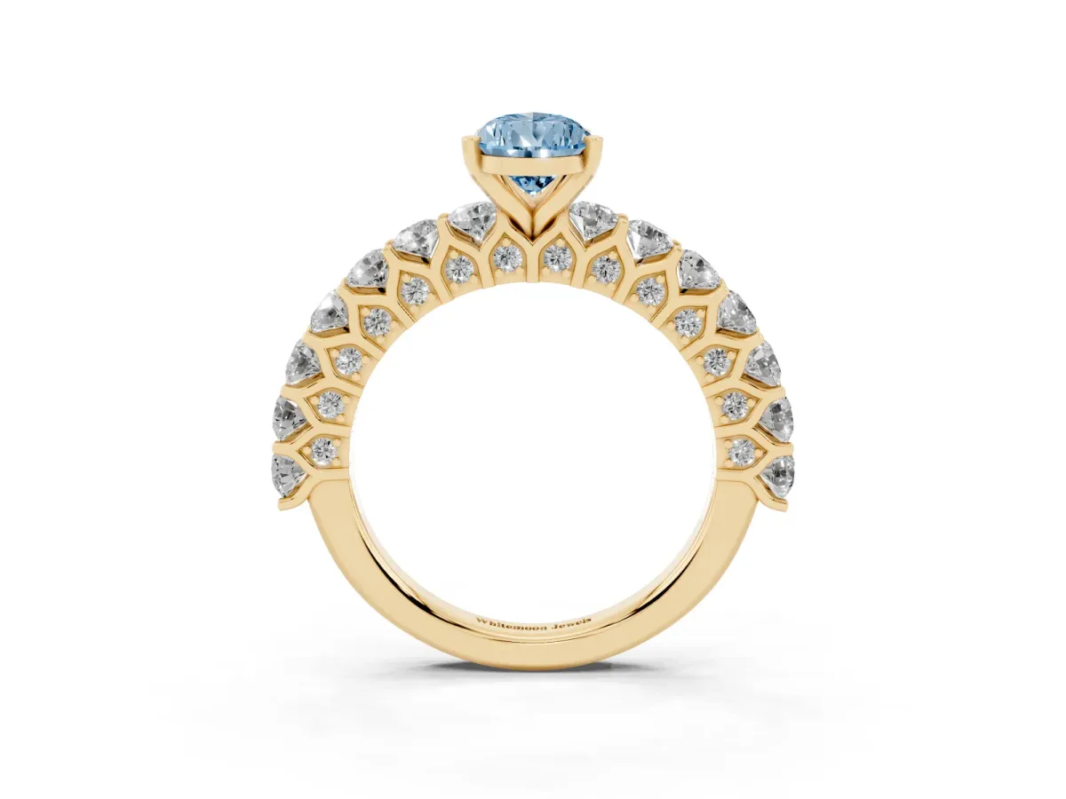 Fancy Blue Pear Cut Diamond Solitaire Ring with Shared Prong Pavé Band and Four-Prong Setting Yellow gold