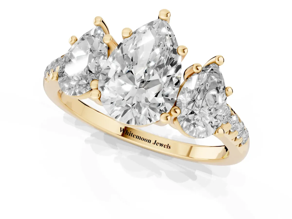 Three-Stone Pear Cut Diamond Ring with Round Pavé Band and Prong Setting Yellow gold