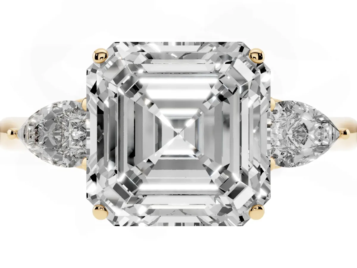 Three-Stone Asscher Cut Diamond Ring with Pear Side Stones in Four-Prong Setting Yellow gold