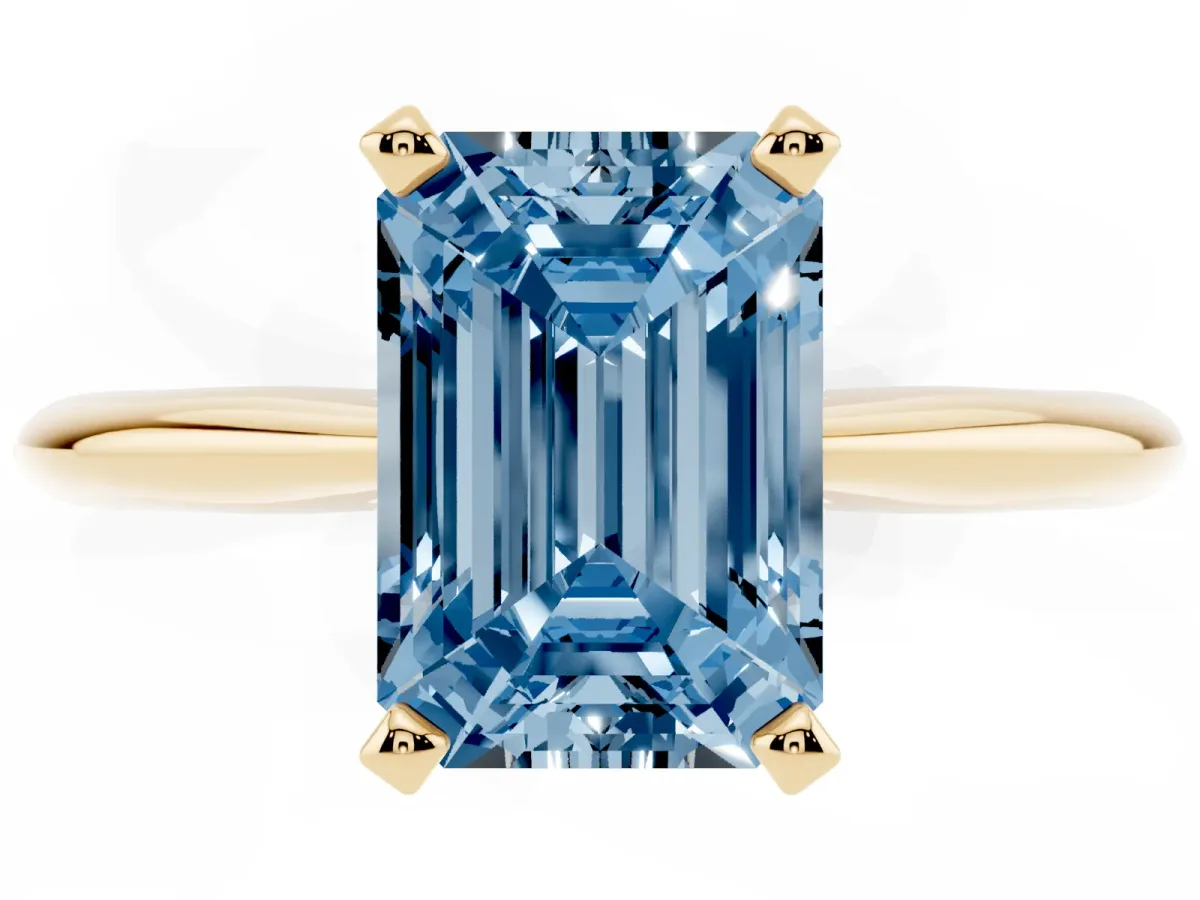 Fancy Blue Emerald Cut Cut Solitaire Ring with Four-Prong Setting on a Classic Band Yellow gold