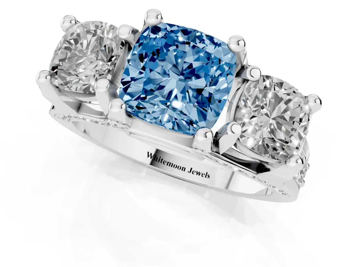 Fancy Blue Cushion Cut Diamond Three-Stone Ring with Channel Set Band and Four-Prong Setting White gold