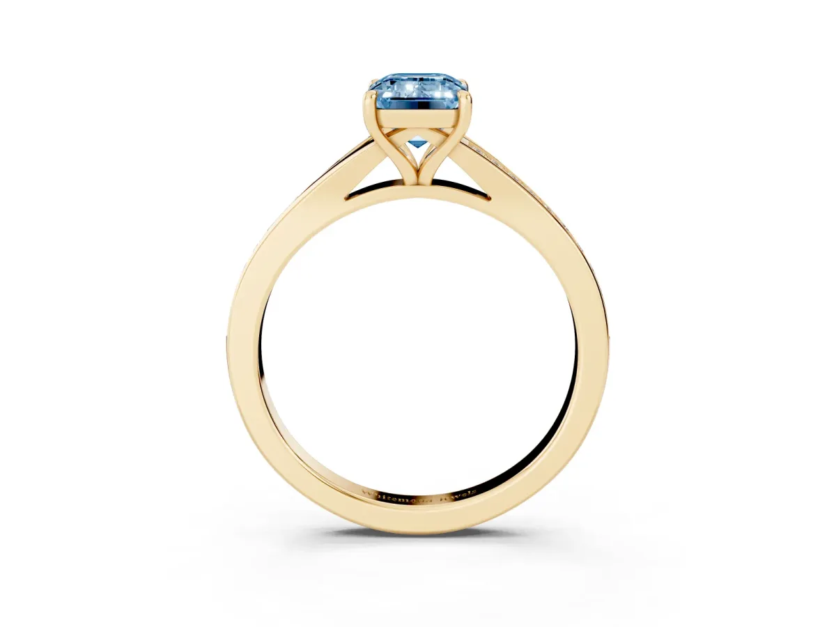 Fancy Blue Emerald Cut Diamond Solitaire Ring with Pavé Band and Prong Setting Yellow gold