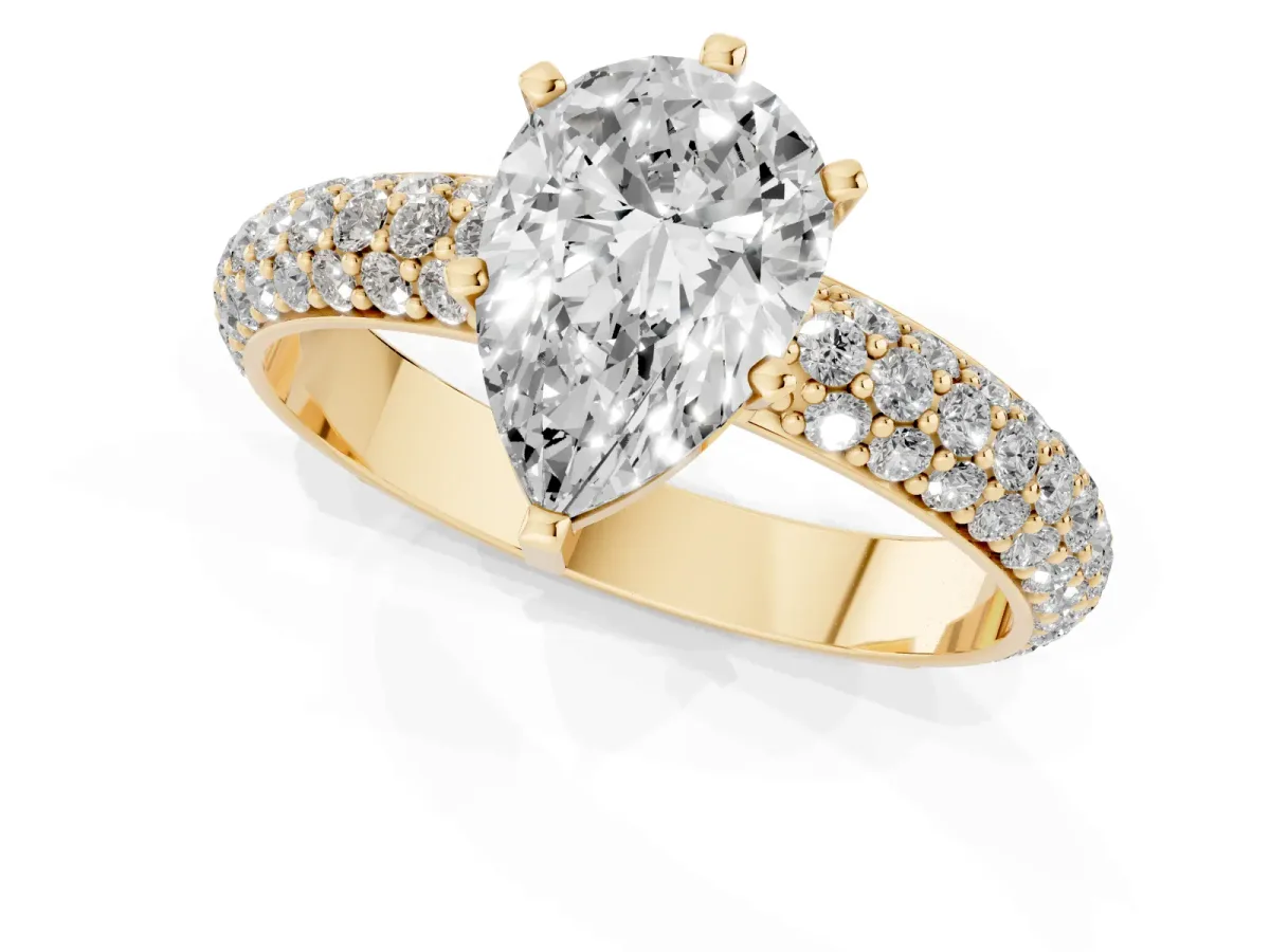 Pear Cut Diamond Solitaire Ring with Prong Setting and Pavé Band Yellow gold