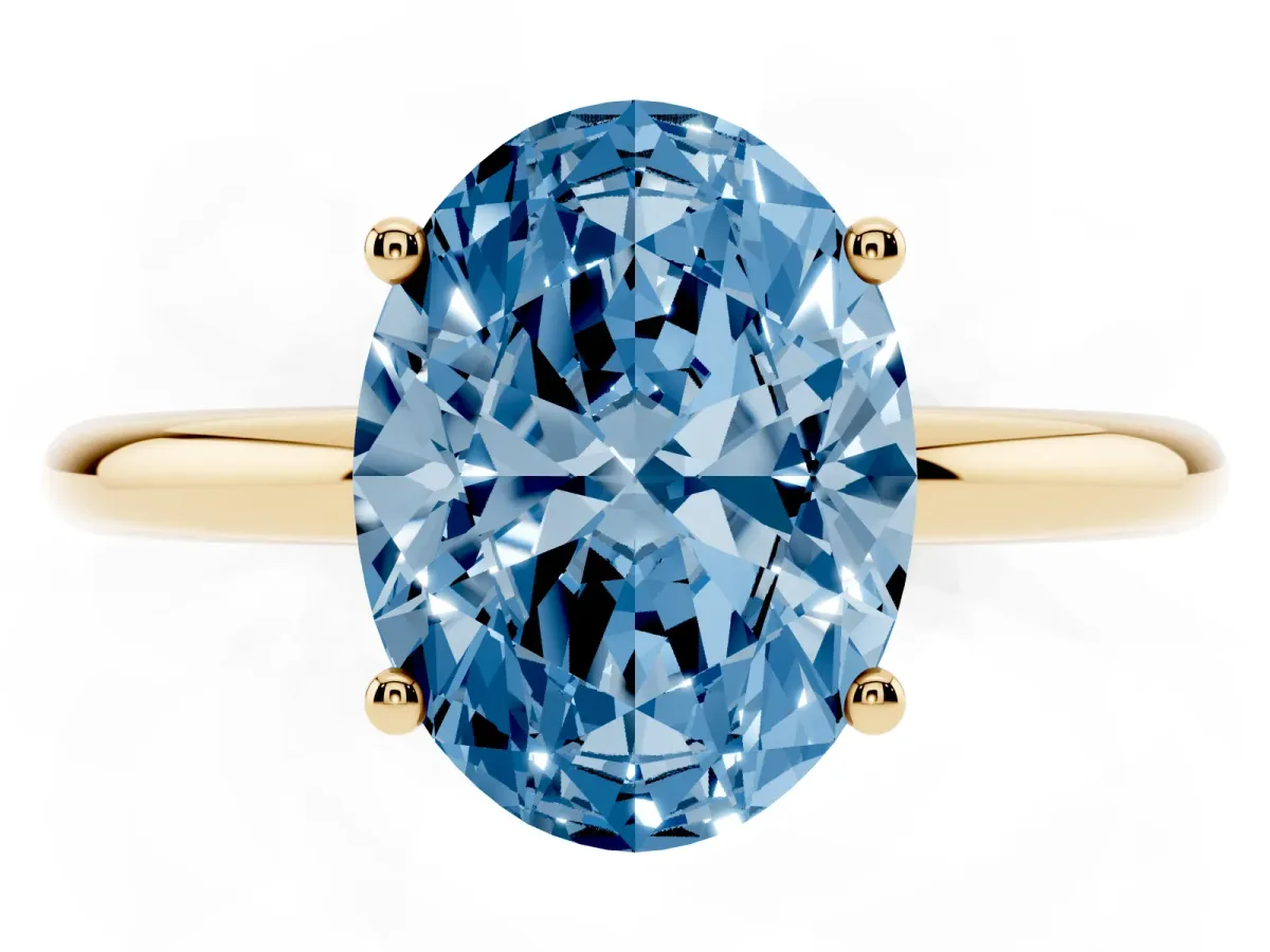 Fancy Blue Oval Cut Cut Solitaire Engagement Ring with Four-Prong Setting and Classic Band Yellow gold