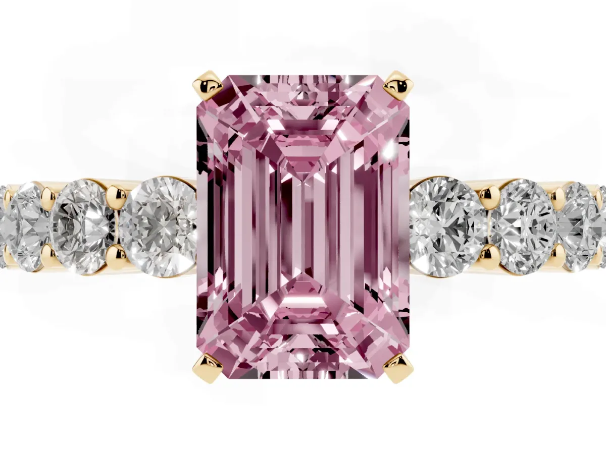 Fancy Pink Emerald Cut Diamond Solitaire Ring with Shared Prong Round Side Stones Yellow gold