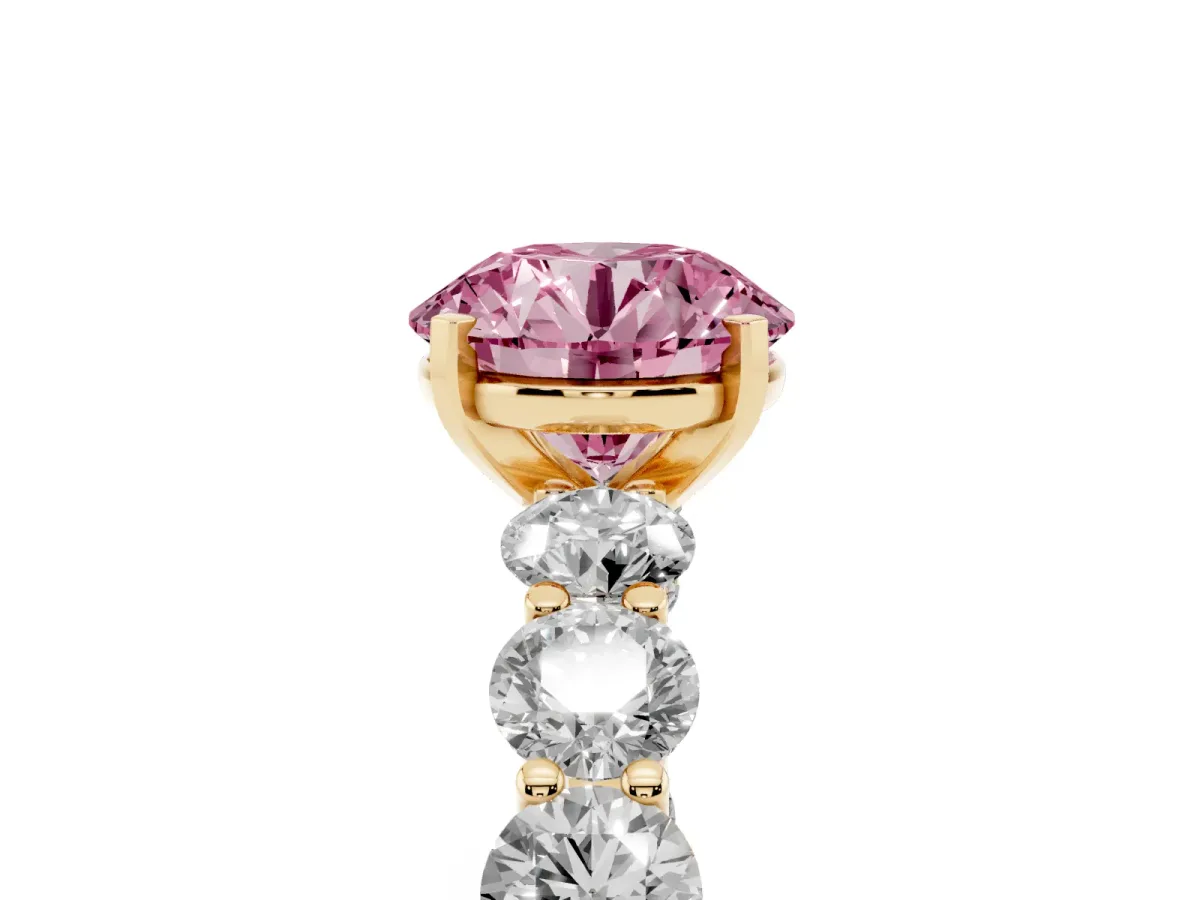 Fancy Pink Round Cut Diamond Prong Setting with Side Stones on a Pave Band Yellow gold