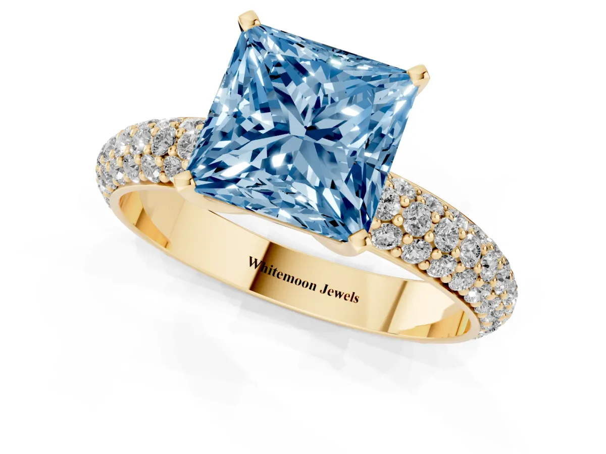 Fancy Blue Princess Cut Diamond Solitaire Ring with Prong Setting and Pavé Band Yellow gold