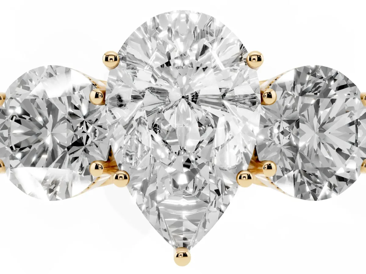 Three-Stone Pear Cut Diamond Engagement Ring with Prong Setting on a Classic Band Yellow gold