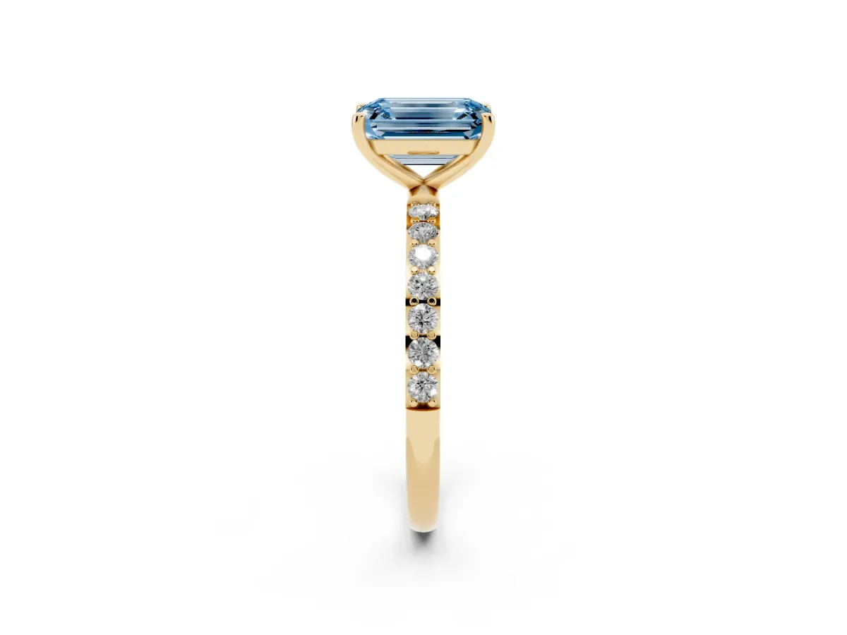 Fancy Blue Emerald Cut Diamond Solitaire Ring with Round Pavé Shoulders and Prong Setting Yellow gold