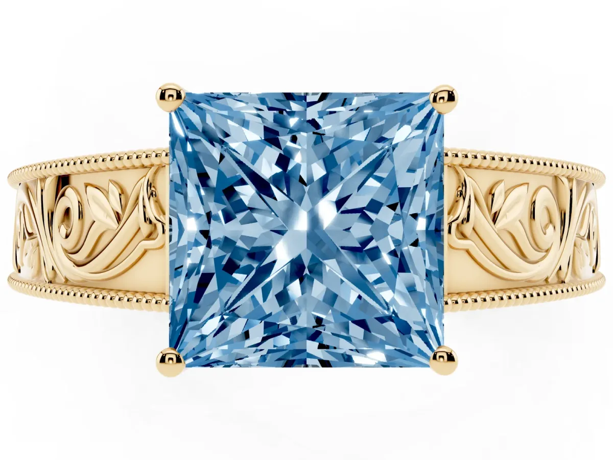 Fancy Blue Princess Cut Diamond Solitaire Ring with Engraved Band and Four-Prong Setting Yellow gold