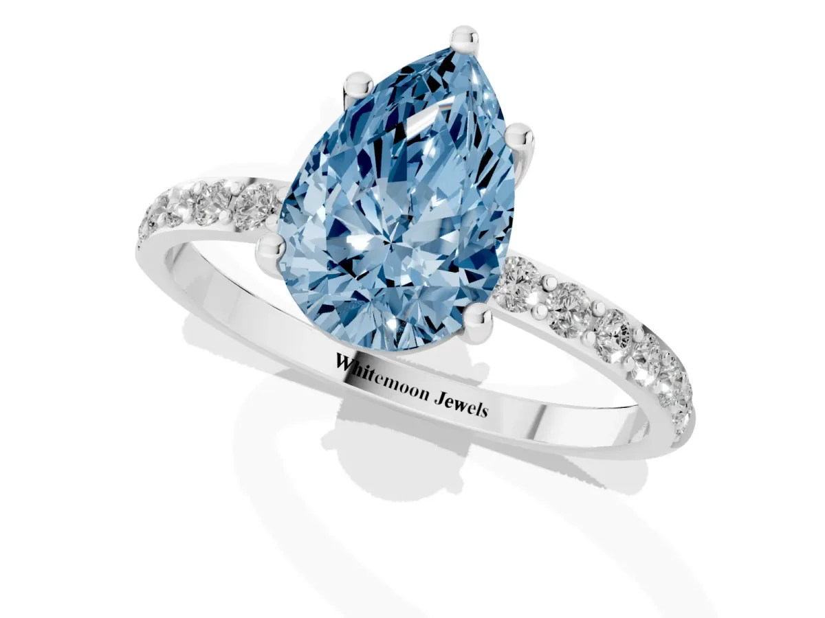 Fancy Blue Pear Cut Diamond Solitaire Ring with Round Pavé Shoulders and Prong Setting Silver