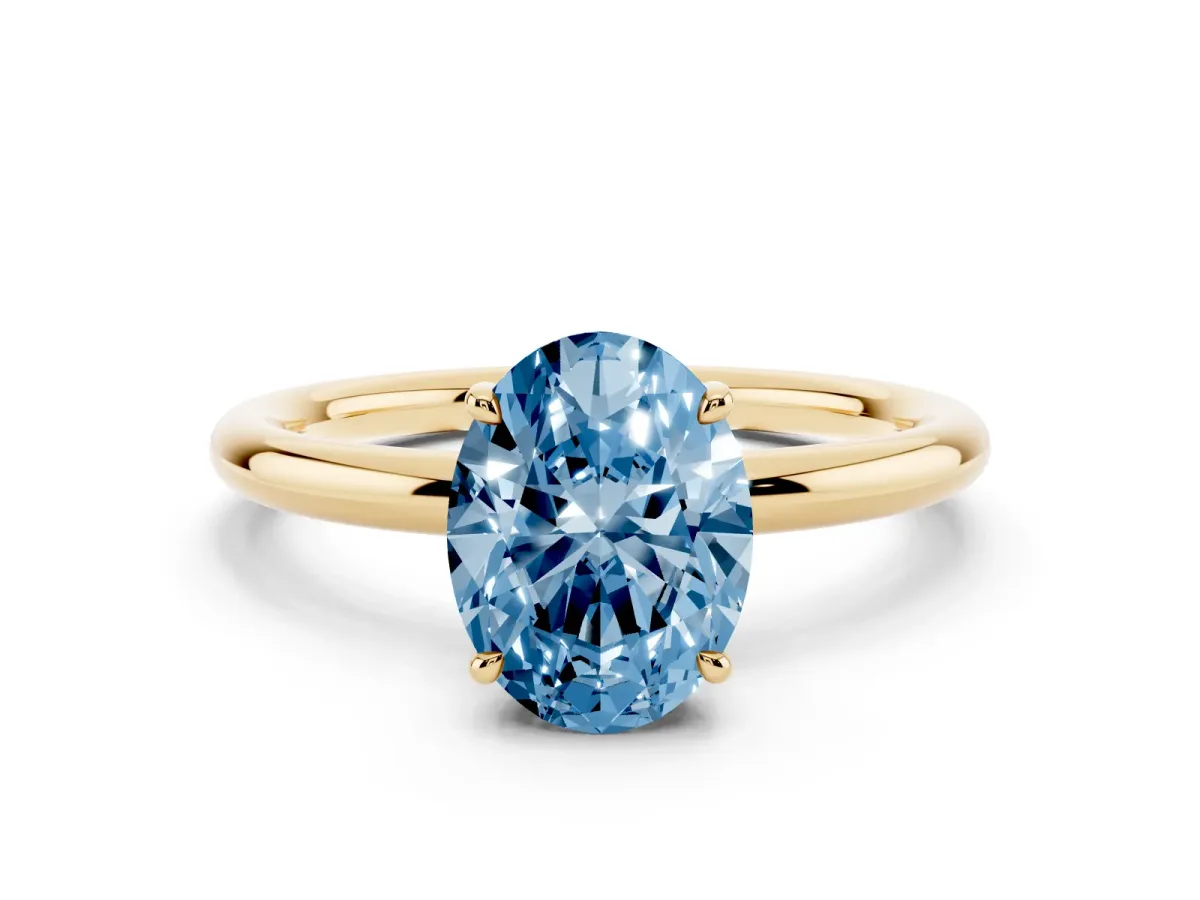 Fancy Blue Oval Cut Diamond Solitaire Ring with Thin Band and Four-Prong Setting Yellow gold