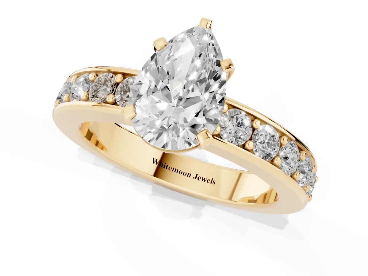 Pear Cut Diamond Engagement Ring with Channel Set Round Band and Prong Setting Yellow gold