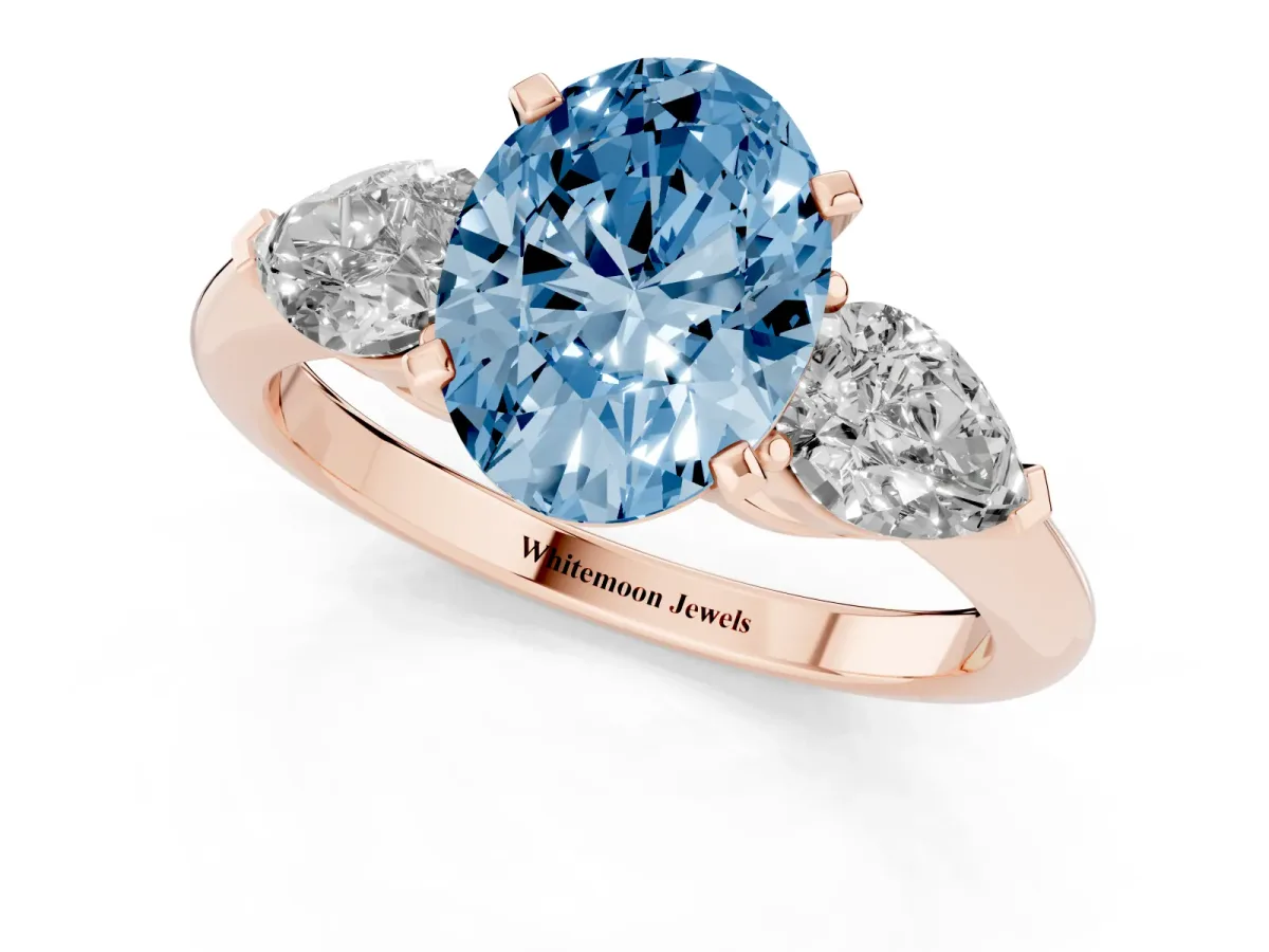 Fancy Blue Three-Stone Oval Cut Diamond Ring with Pear Side Stones and Four-Prong Setting Rose gold