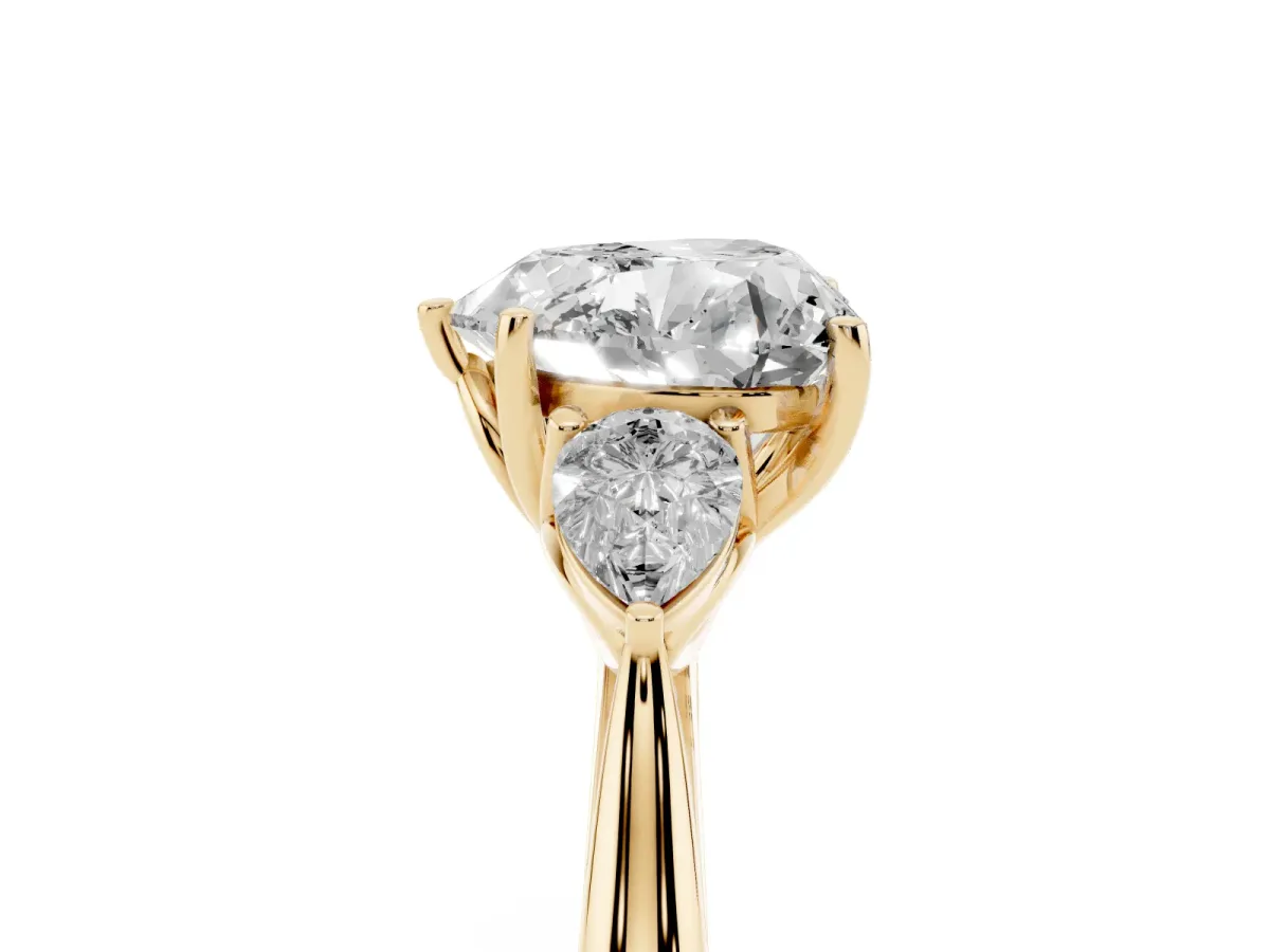 Three-Stone Heart Cut Diamond Ring with Pear Side Stones in Four-Prong Setting Yellow gold