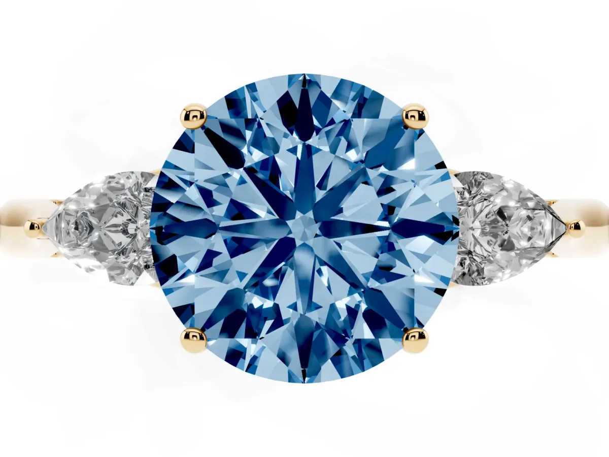 Fancy Blue Three-Stone Round Cut Diamond Ring with Pear Side Stones in Four-Prong Setting Yellow gold