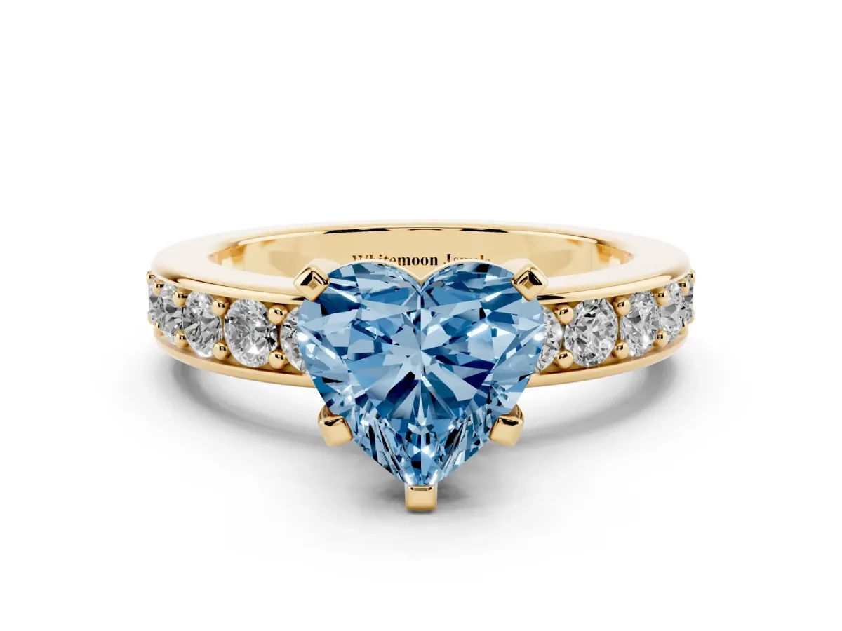 Fancy Blue Heart Cut Diamond Engagement Ring with Channel Set Round Band and Prong Setting Yellow gold