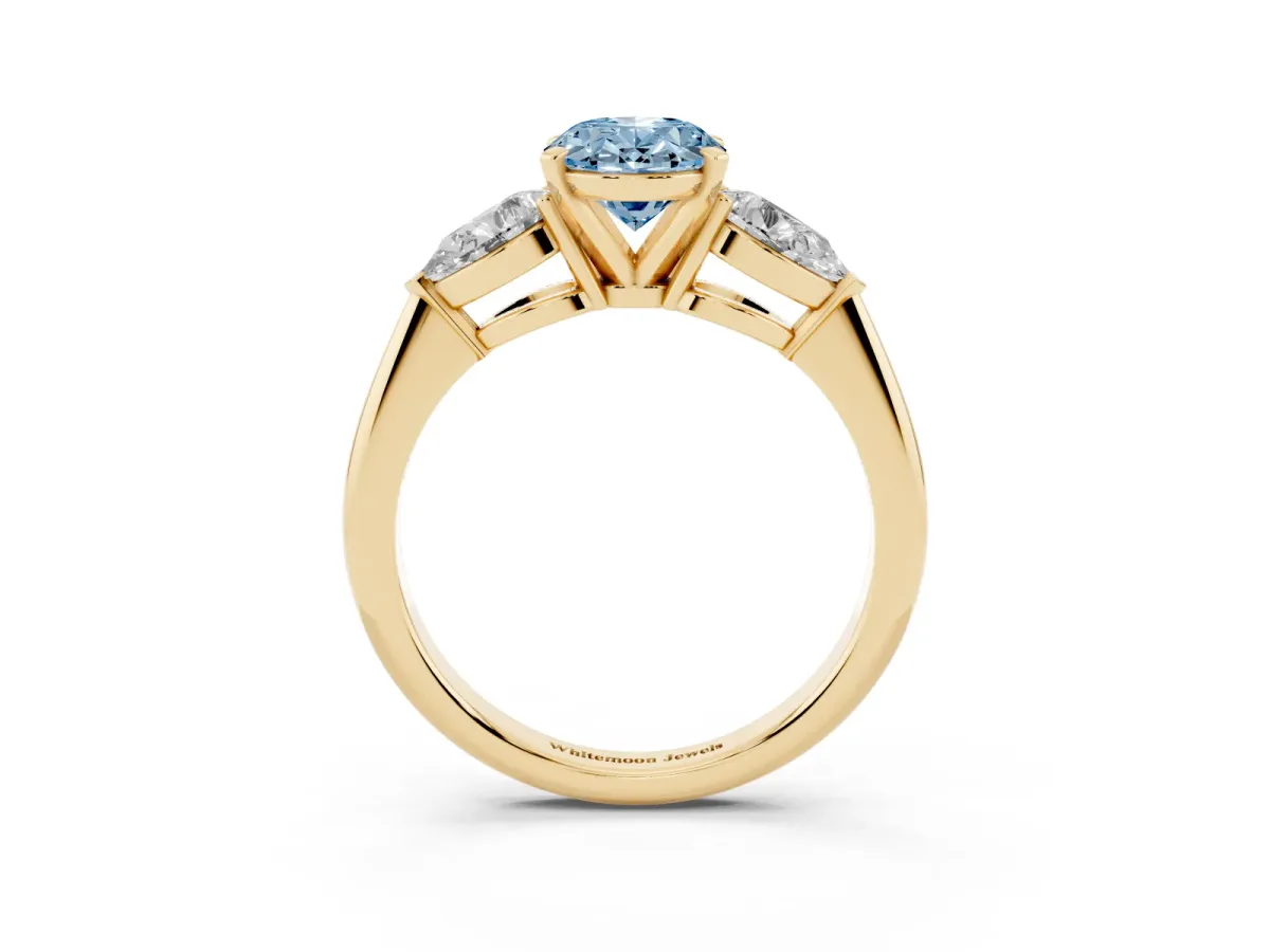 Fancy Blue Three-Stone Oval Cut Diamond Ring with Pear Side Stones and Four-Prong Setting Yellow gold