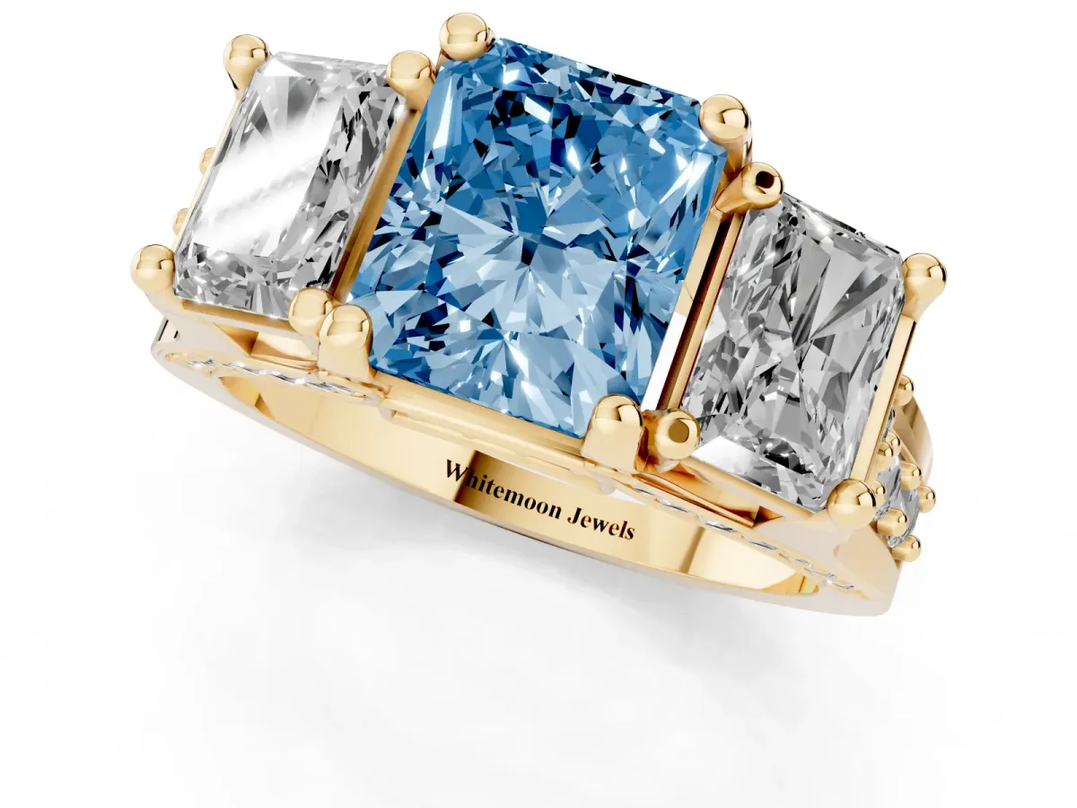 Fancy Blue Radiant Cut Diamond Three-Stone Ring with Channel Set Band and Four-Prong Setting Yellow gold