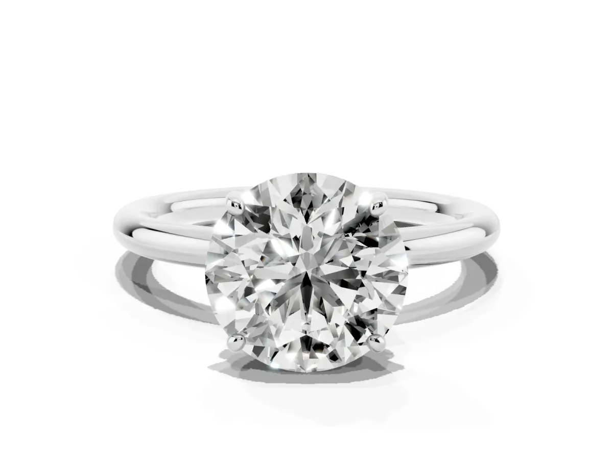 Round Cut Solitaire Diamond Ring with Four-Prong Setting on a Plain Band Platinum