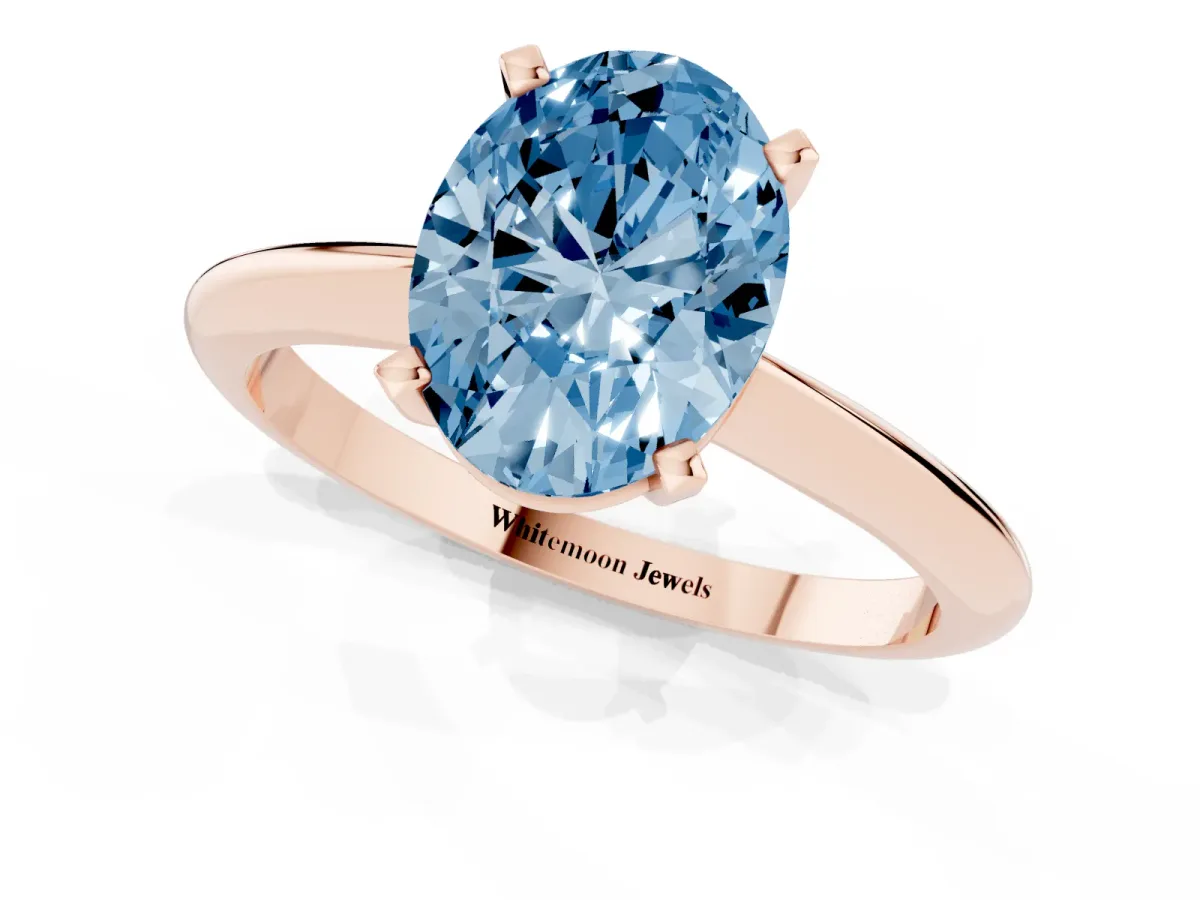 Fancy Blue Oval Cut Cut Solitaire Ring with Four-Prong Setting on a Classic Band Rose gold