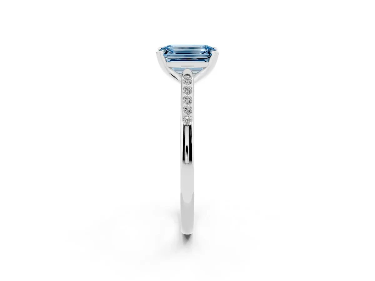 Fancy Blue Emerald Cut Diamond Solitaire Ring with Channel Set Round Band and Prong Setting Silver