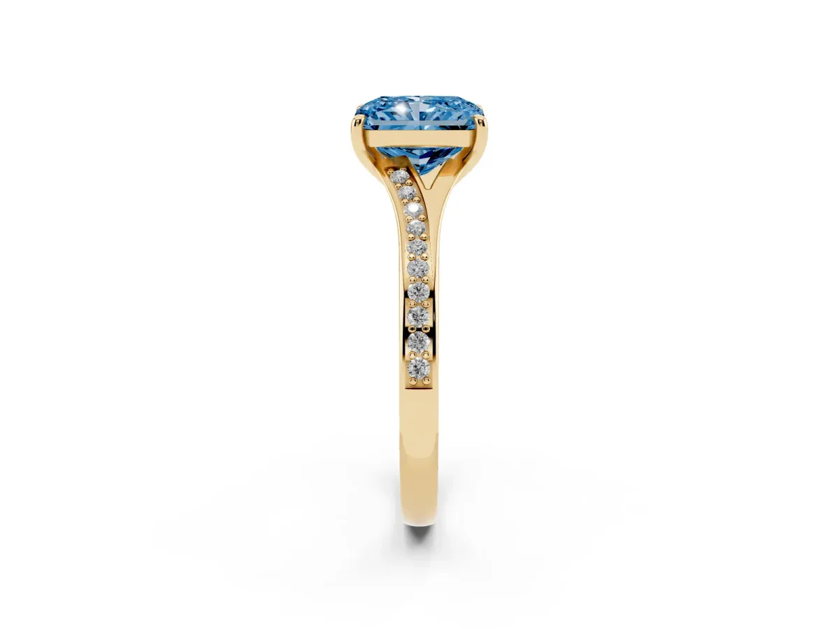 Fancy Blue Radiant Cut Diamond Solitaire Ring with Pavé Band and Prong Setting Yellow gold