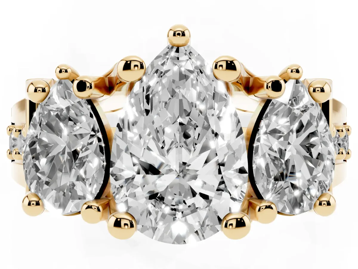 Pear Cut Diamond Three-Stone Ring with Channel Set Band and Four-Prong Setting Yellow gold