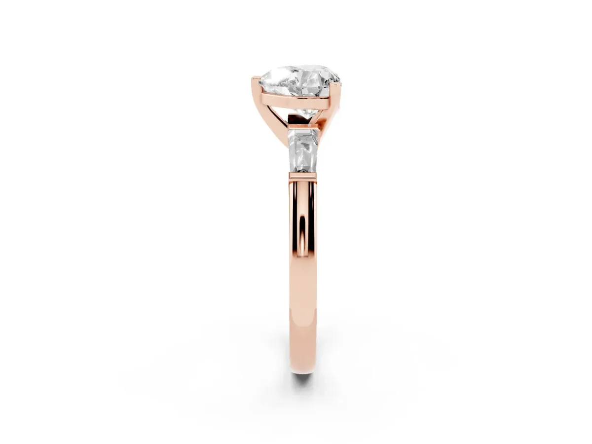 Heart Cut Solitaire with Tapered Baguette Side Stones on a Classic Band with Four-Prong Setting Rose gold