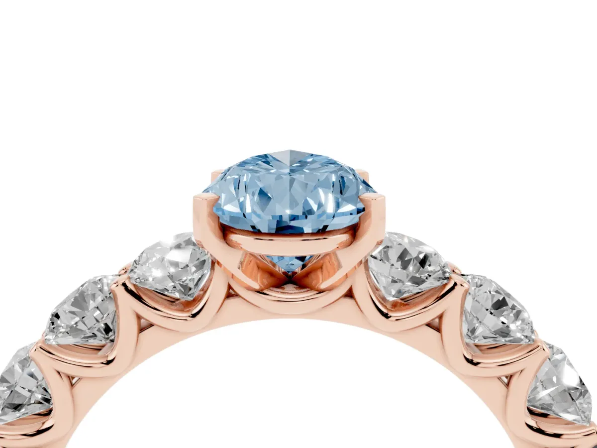 Fancy Blue Pear Cut Diamond Prong Setting with Side Stones on a Pave Band Rose gold