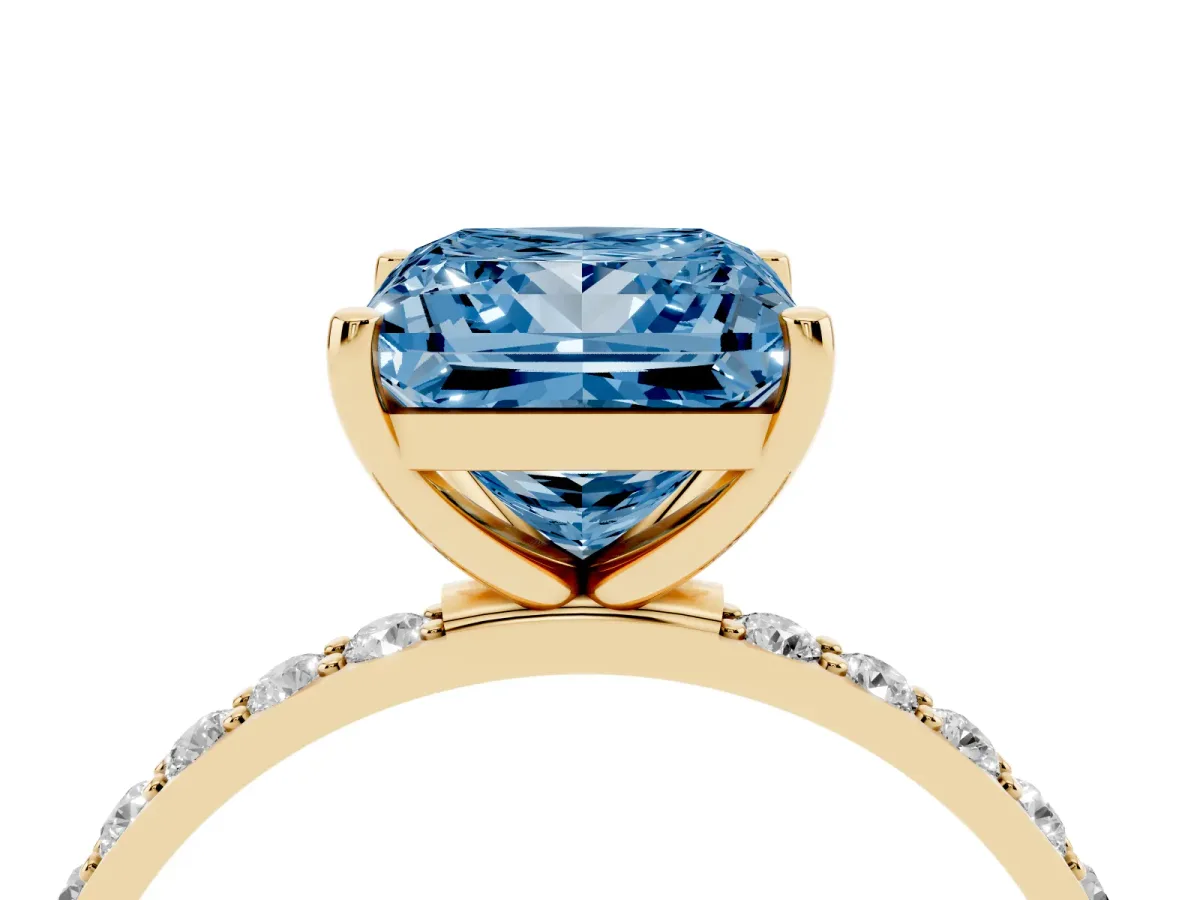 Fancy Blue Princess Cut Diamond Solitaire Ring with Round Pavé Shoulders and Prong Setting Yellow gold