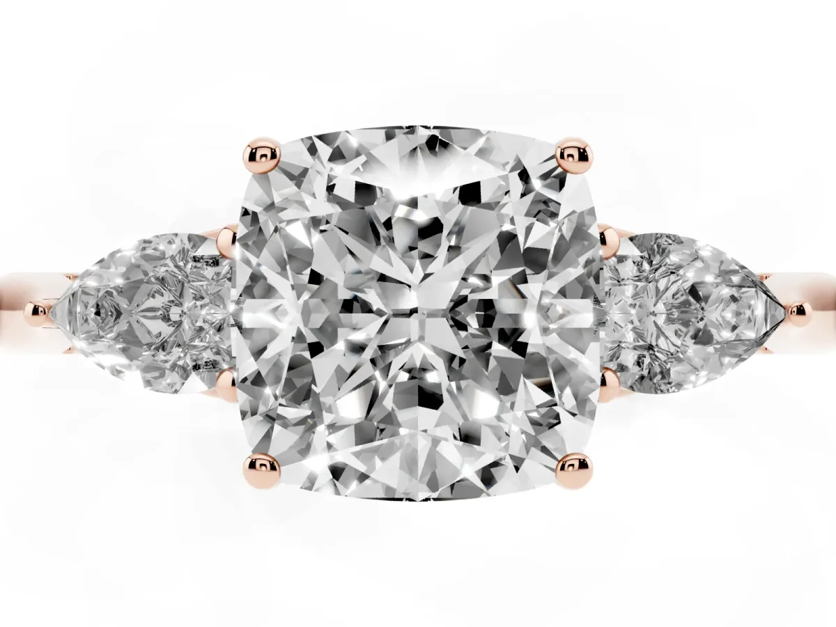 Three-Stone Cushion Cut Diamond Ring with Pear Side Stones in Four-Prong Setting Rose gold