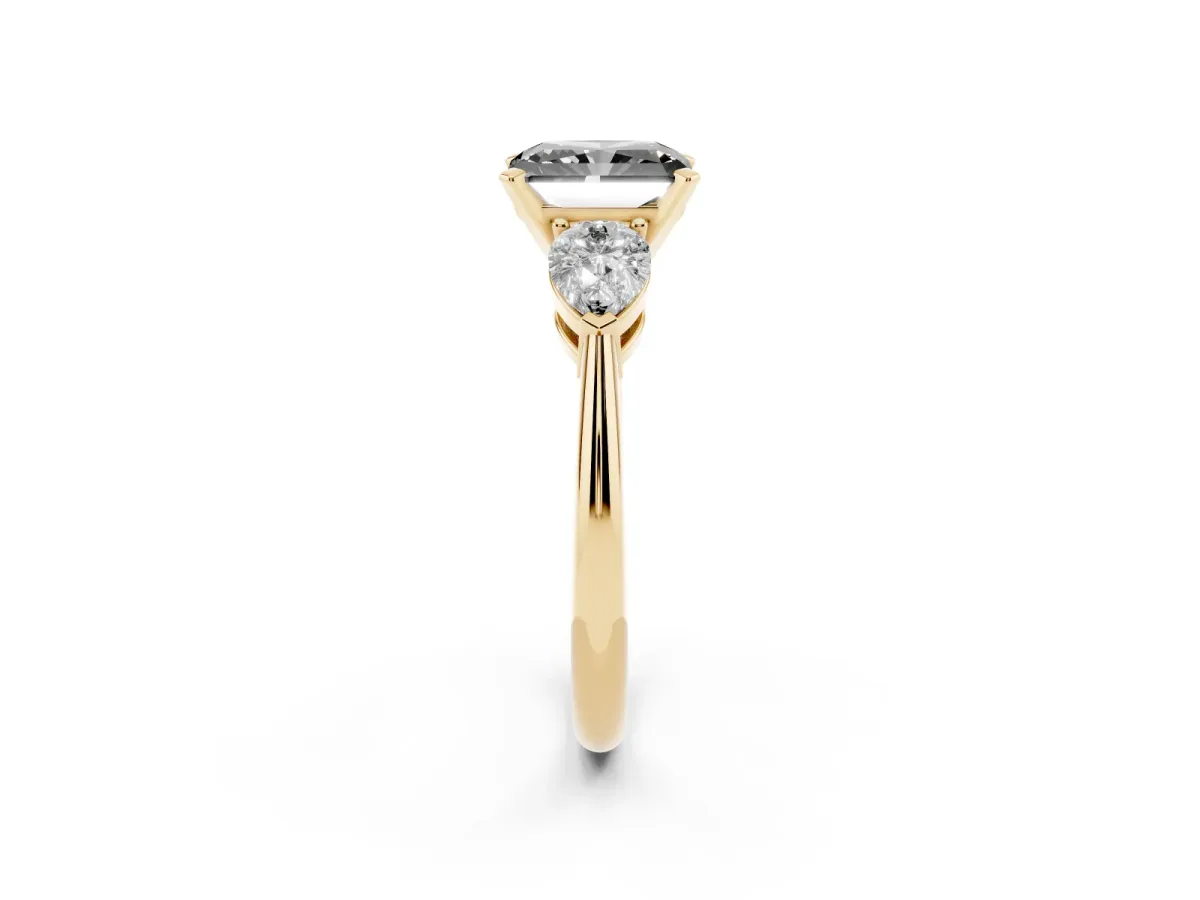 Fancy Black Three-Stone Radiant Cut Diamond Ring with Pear Side Stones and Four-Prong Setting Yellow gold