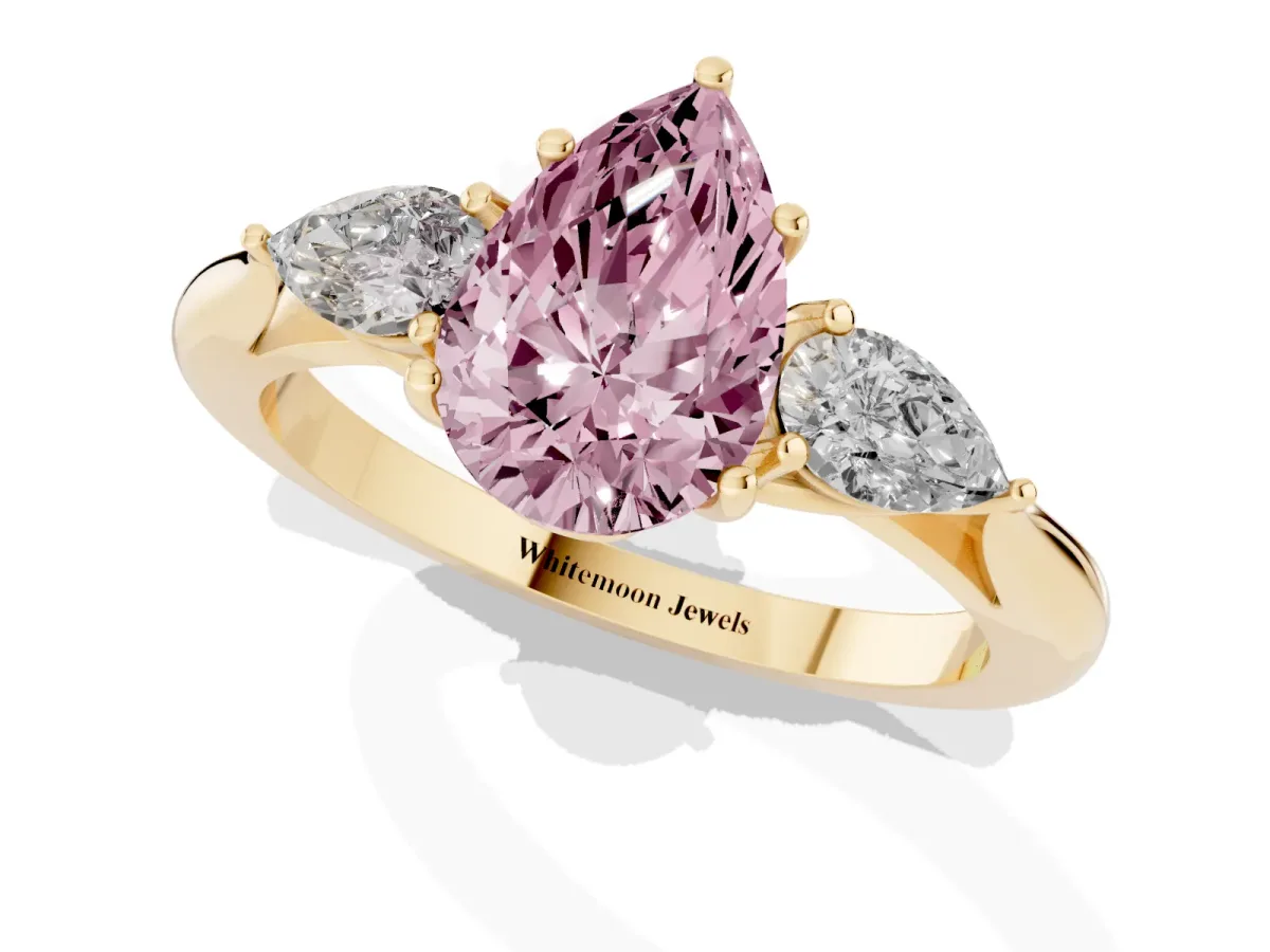 Fancy Pink Three-Stone Pear Cut Diamond Ring with Pear Side Stones in Four-Prong Setting Yellow gold