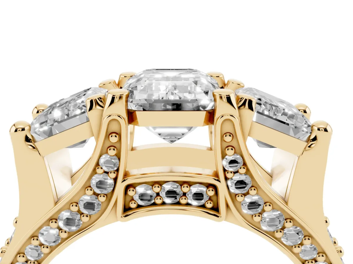 Emerald Cut Diamond Three-Stone Ring with Channel Set Band and Four-Prong Setting Yellow gold
