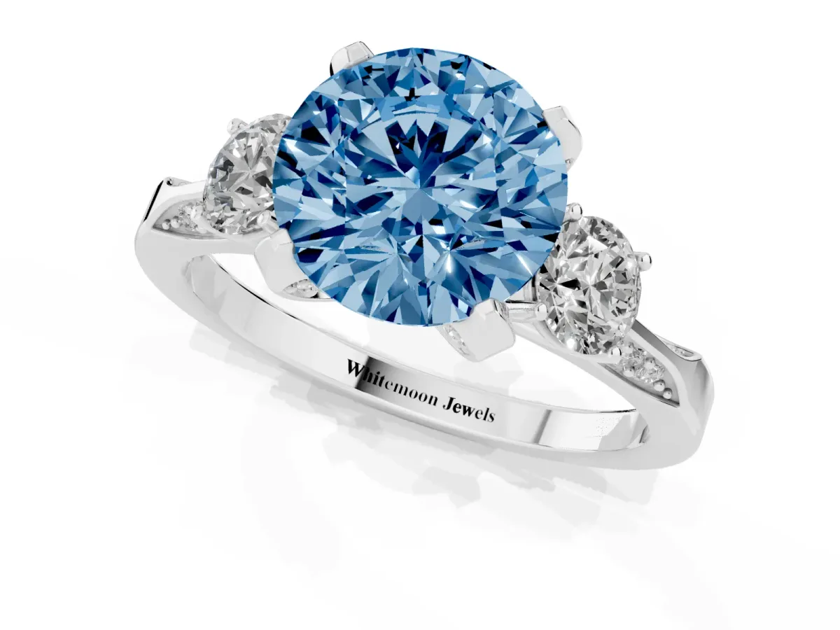 Fancy Blue Round Cut Brilliant Three-Stone Diamond Ring with Pavé Band and Four-Prong Setting Silver