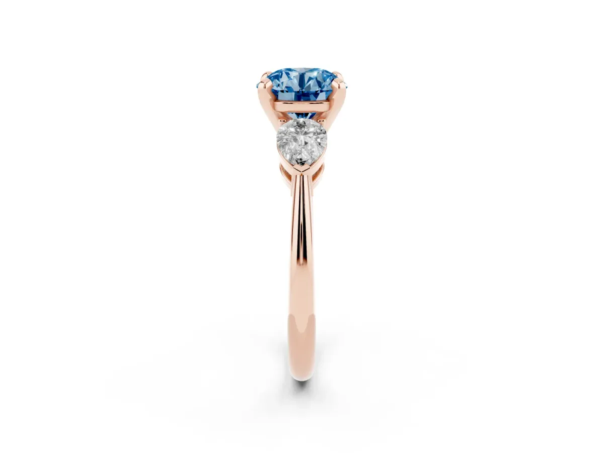 Fancy Blue Three-Stone Round Cut Diamond Ring with Pear Side Stones and Four-Prong Setting Rose gold