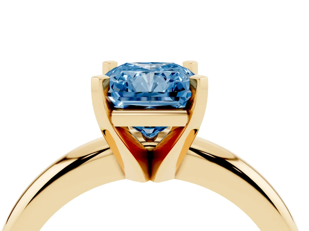 Fancy Blue Radiant Cut Diamond Solitaire Engagement Ring with Round Band and Four-Prong Setting Yellow gold