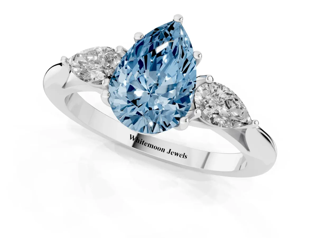 Fancy Blue Three-Stone Pear Cut Brilliant Diamond Solitaire Ring with Tapered Band and Four-Prong Setting White gold
