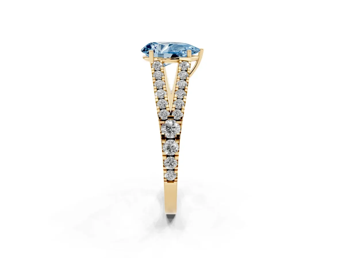 Fancy Blue Pear Cut Diamond Split Shank Engagement Ring with Round Pavé and Prong Setting Yellow gold