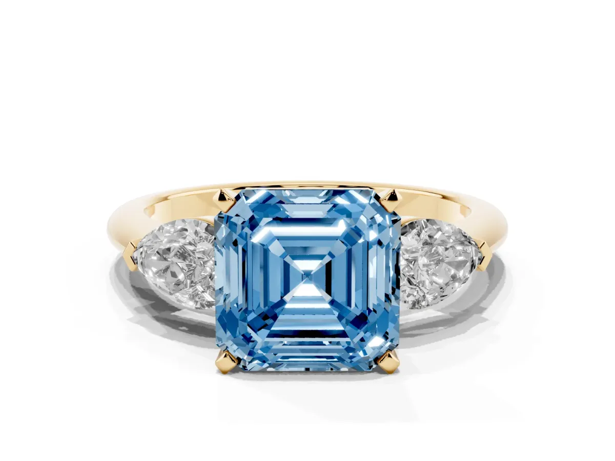 Fancy Blue Three-Stone Asscher Cut Diamond Ring with Pear Side Stones and Four-Prong Setting Yellow gold
