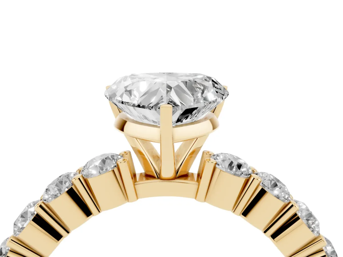 Heart Cut Diamond Solitaire Ring with Shared Prong Round Side Stones Yellow gold