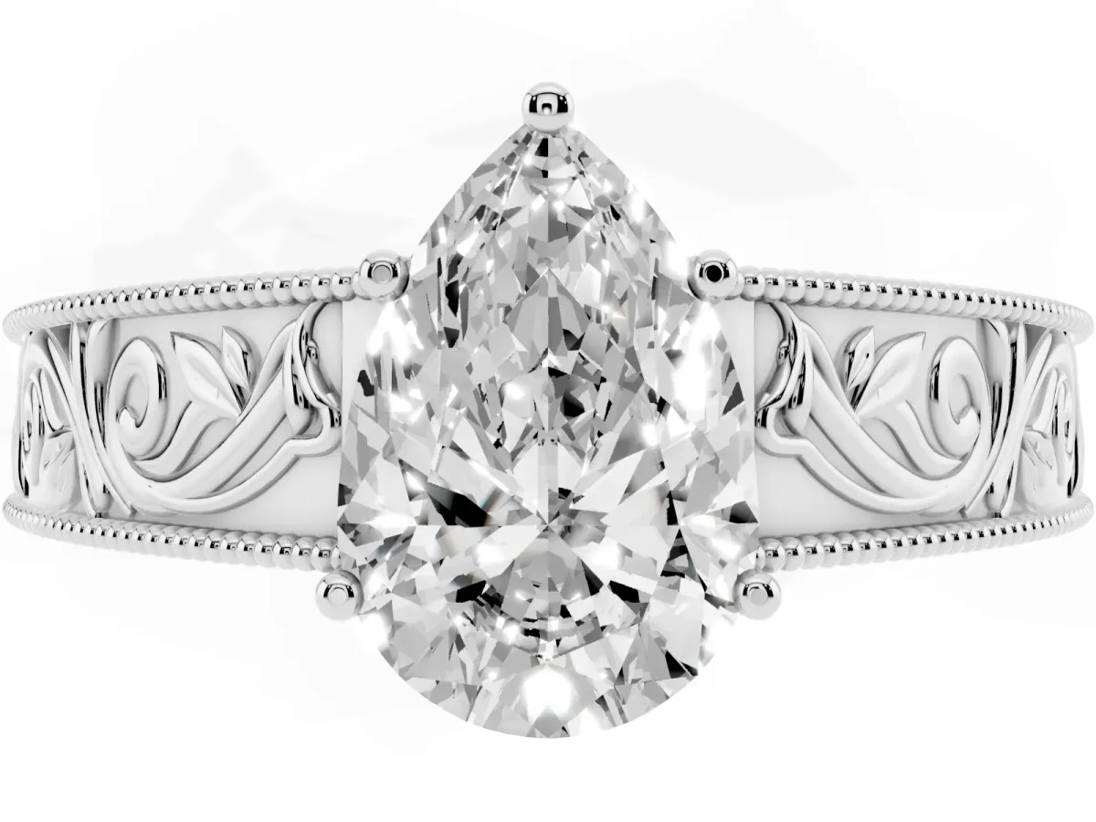 Pear Cut Diamond Solitaire Ring with Engraved Band and Four-Prong Setting Silver