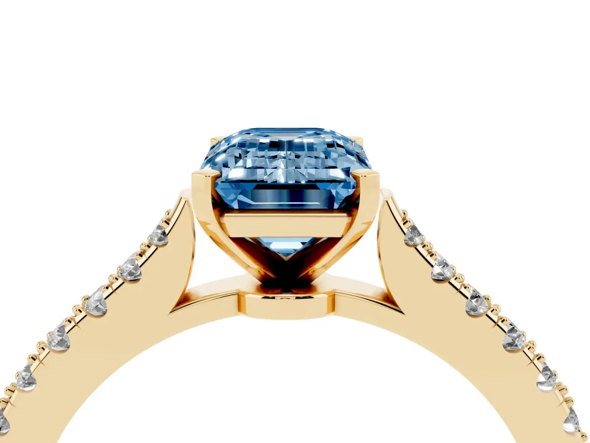 Fancy Blue Emerald Cut Cut Solitaire Diamond Engagement Ring with Pave Band and Four-Prong Setting Yellow gold