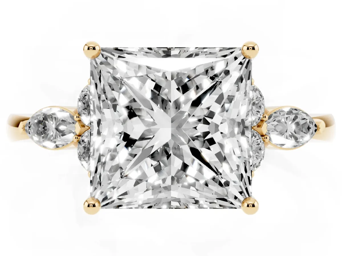Princess Cut Brilliant Diamond Solitaire Ring with Pear Side Stones and Four-Prong Setting Yellow gold