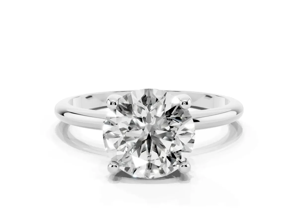 Round Cut Solitaire Diamond Ring with 4-Prong Setting on a Classic Band Platinum