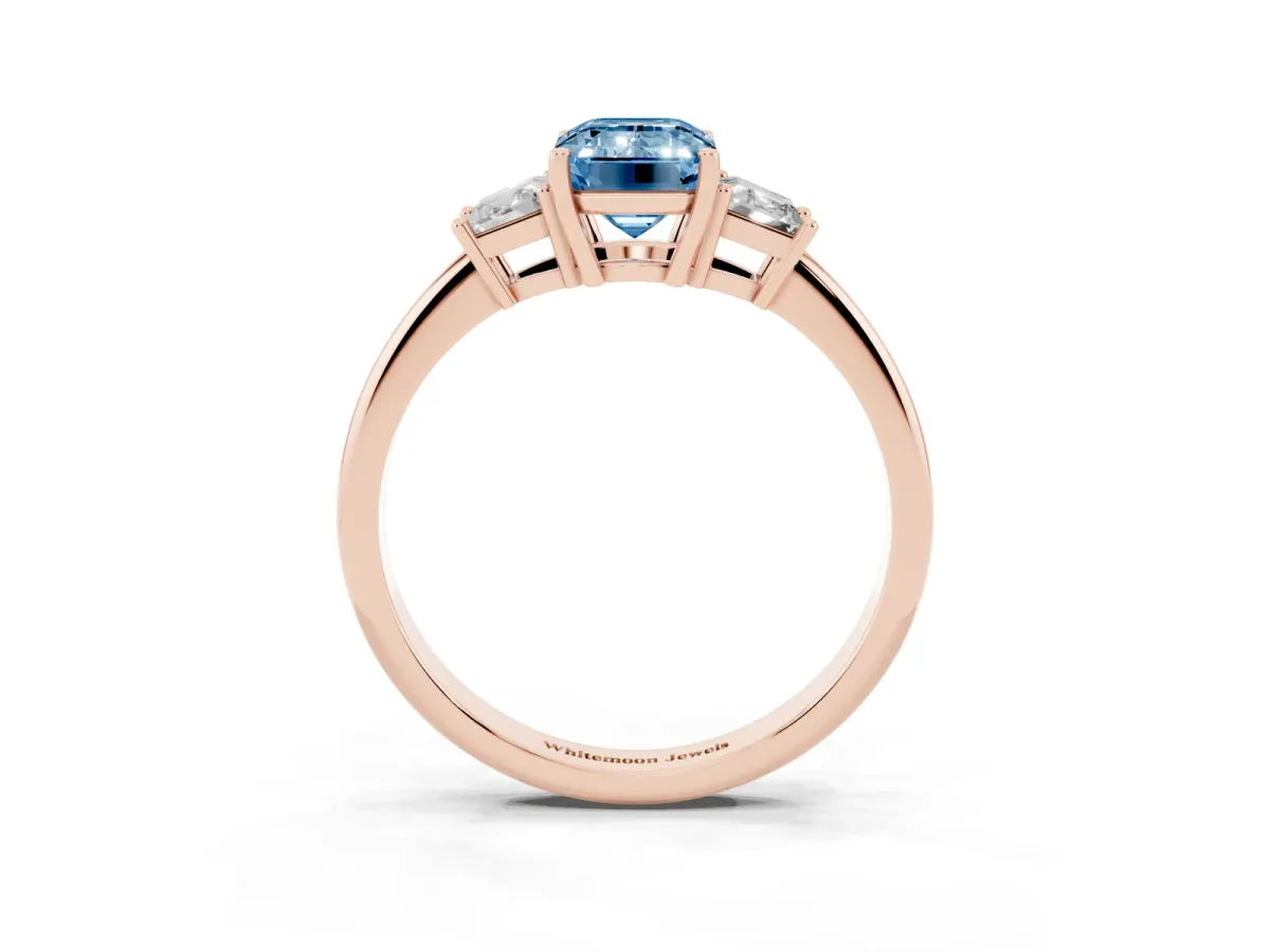 Fancy Blue Emerald Cut Diamond Three-Stone Ring with Trapezoid Side Stones and Prong Setting Rose gold