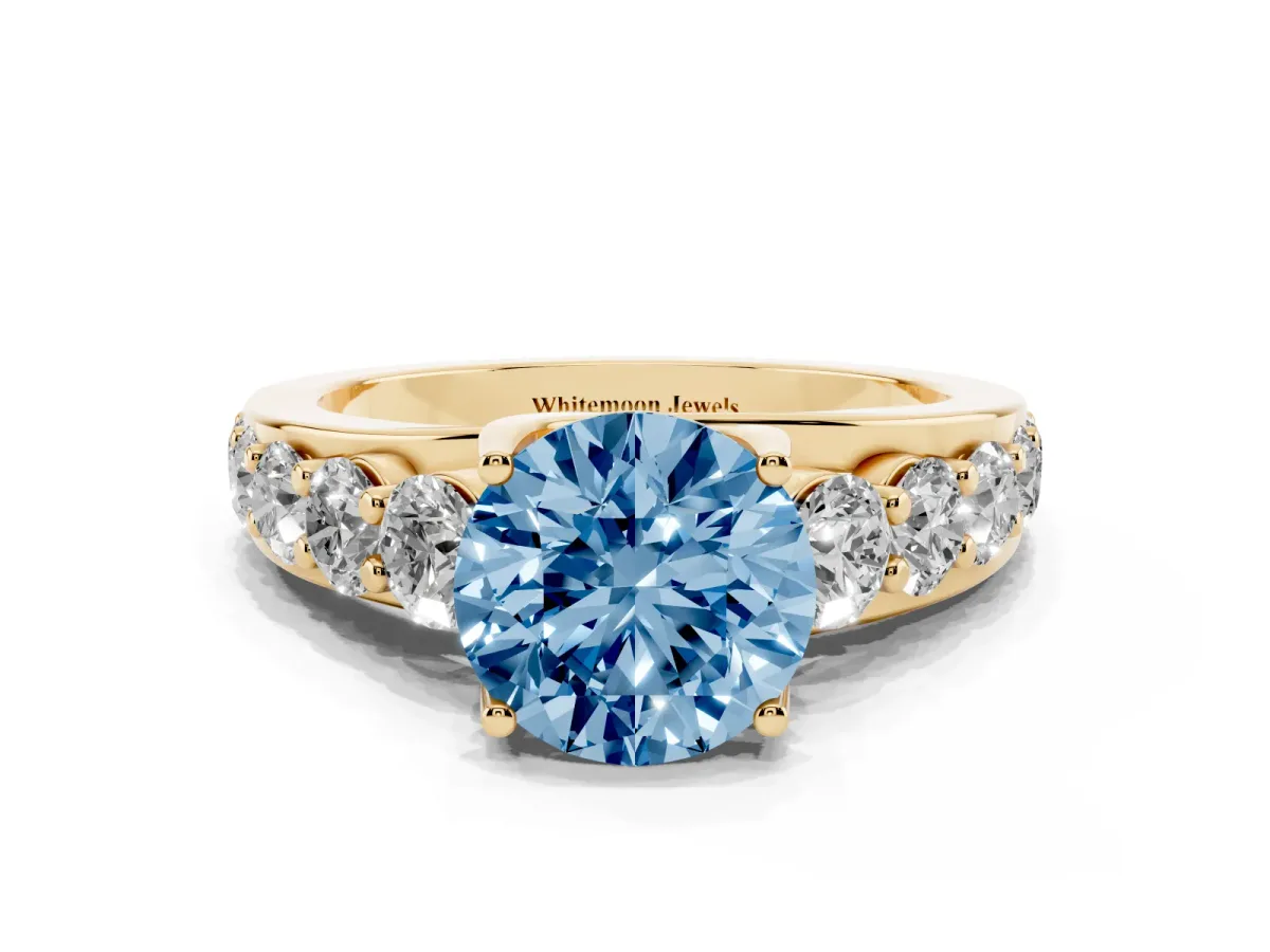 Fancy Blue Round Cut Diamond Engagement Ring with Pavé Band and Four-Prong Setting Yellow gold