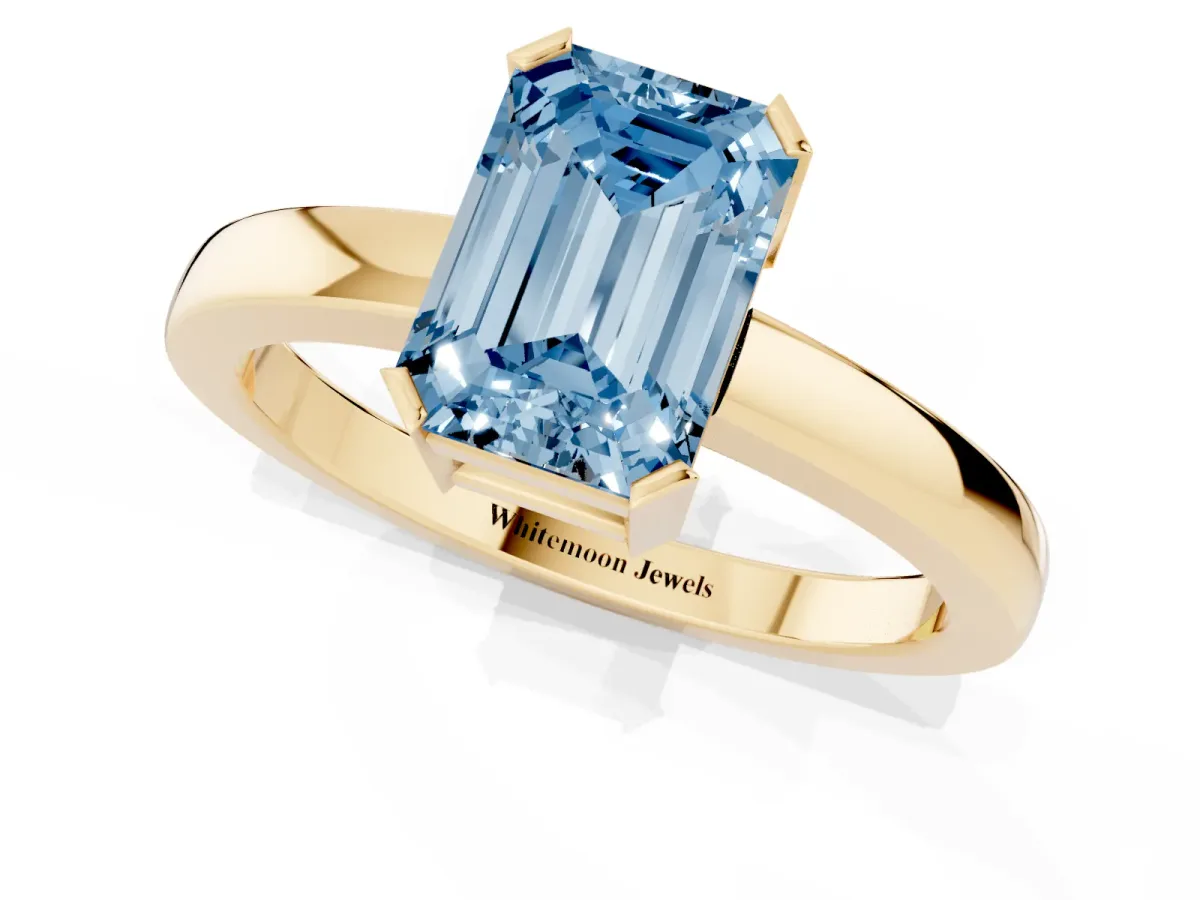 Fancy Blue Emerald Cut Cut Solitaire Ring with Four-Prong Setting and Classic Band Yellow gold